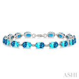 7X5 MM Oval Shape Blue Topaz and 1/10 Ctw Round Cut Diamond Semi-Precious Bracelet in Sterling Silver