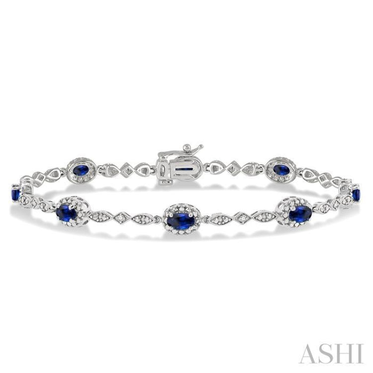 5x3MM Oval Cut Sapphire and 1/20 Ctw Single Cut Diamond Bracelet in 10K White Gold