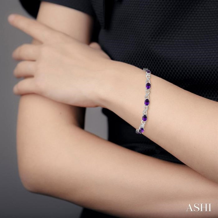 1/10 ctw Round Cut Diamond & 7x5MM Oval Cut Amethyst Semi Precious Infinity Bracelet in Silver