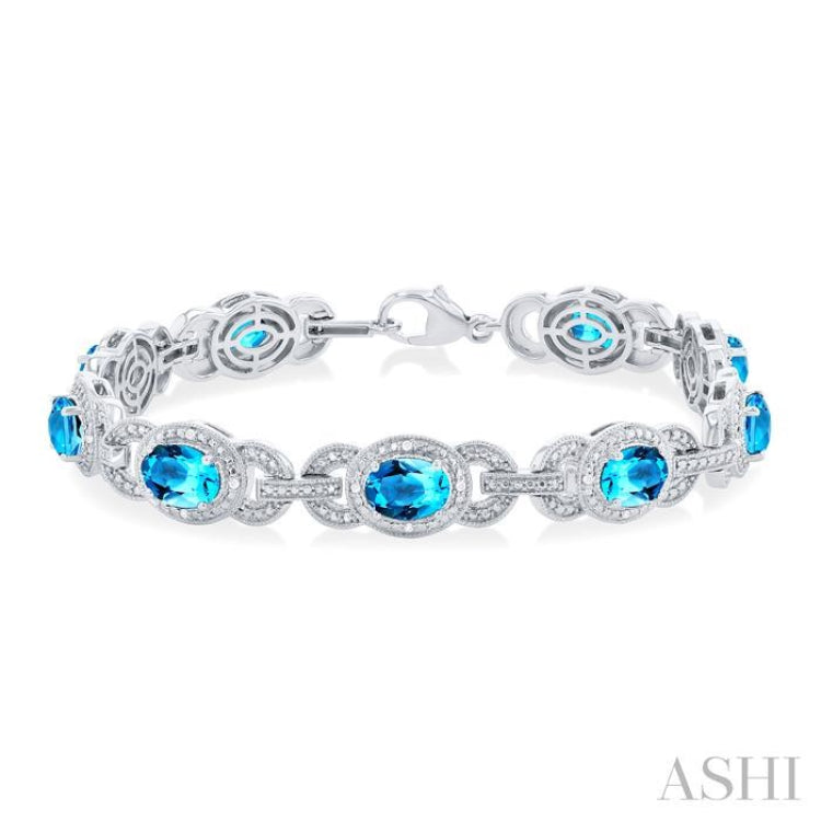 7x5 MM Oval Shape Blue Topaz and 1/10 ctw Round Cut Diamond Semi Precious Bracelet in Sterling Silver