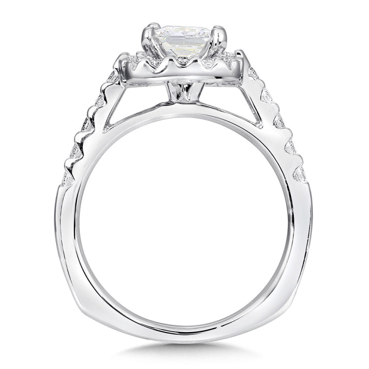 A sparkling cushion shape diamond halo lights up the princess-cut center in this classic diamond fishtail-set ring.