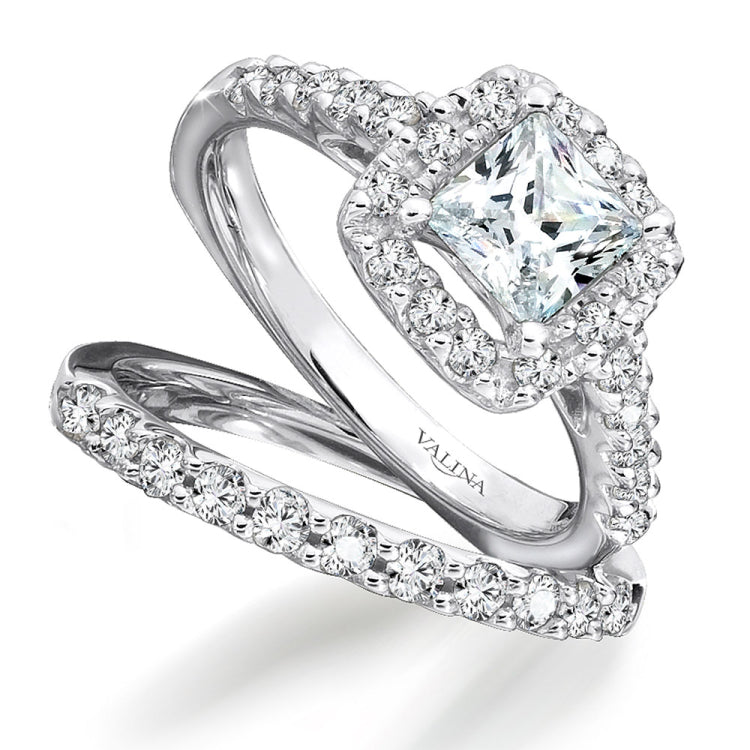 A sparkling cushion shape diamond halo lights up the princess-cut center in this classic diamond fishtail-set ring.